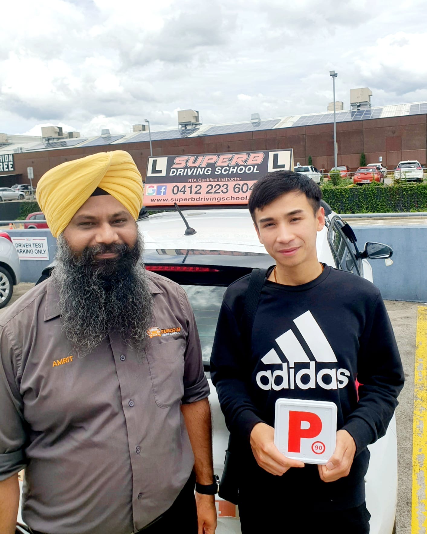 Student celebrating P-plate pass with Amrit